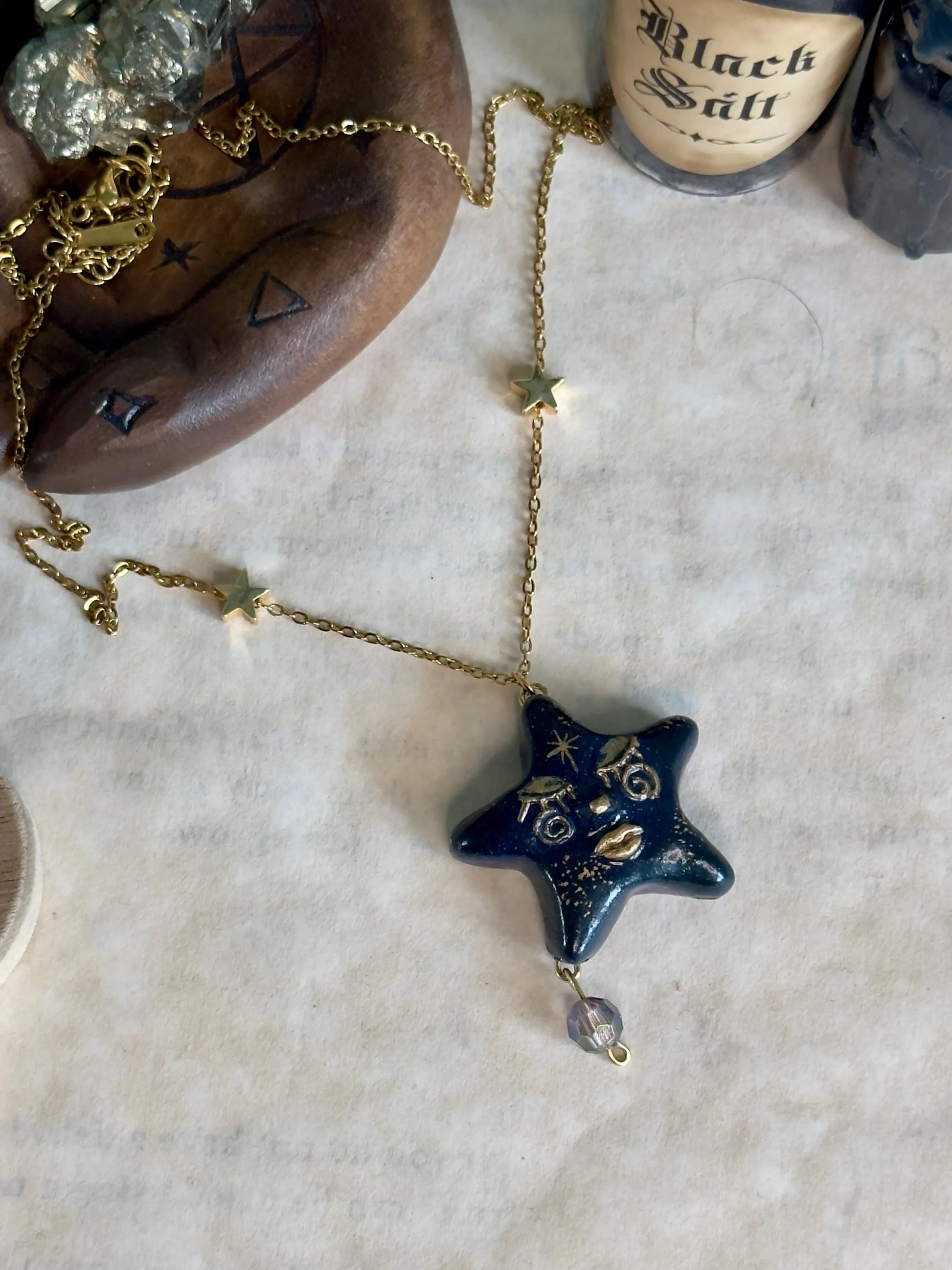 Blue Star-shaped pendant necklace on a marble surface 