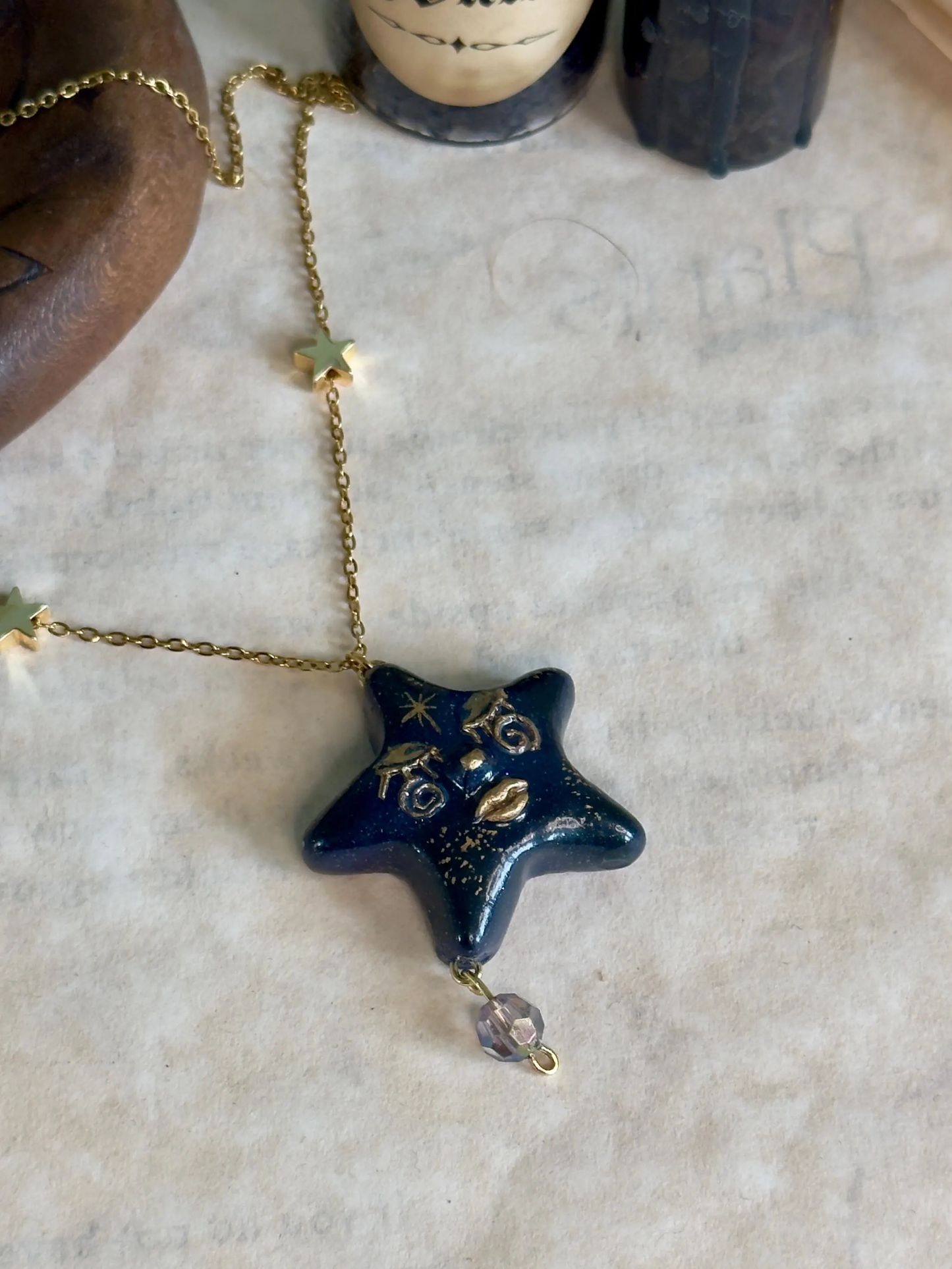 Blue Star-shaped pendant necklace on a textured surface